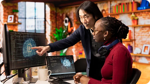 Engineers working together analyzing data and AI architecture on screens